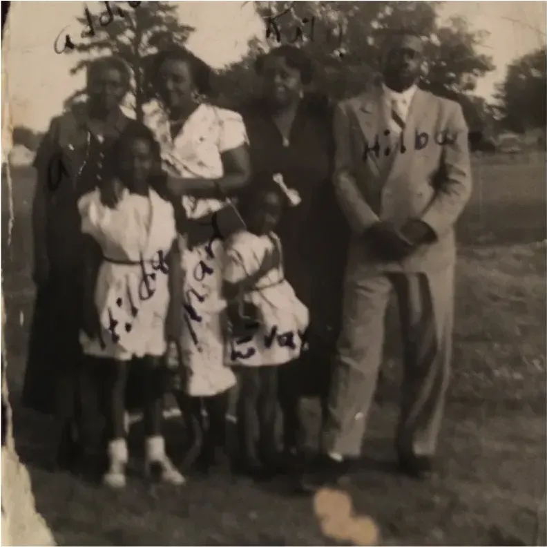 A treasured faded photograph, worn with time, before being restored