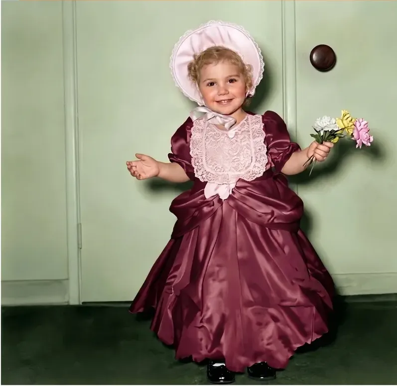 The same 1950s-1970s photograph after hand restoration by MemoryCherish, discoloration repaired and detail recovered