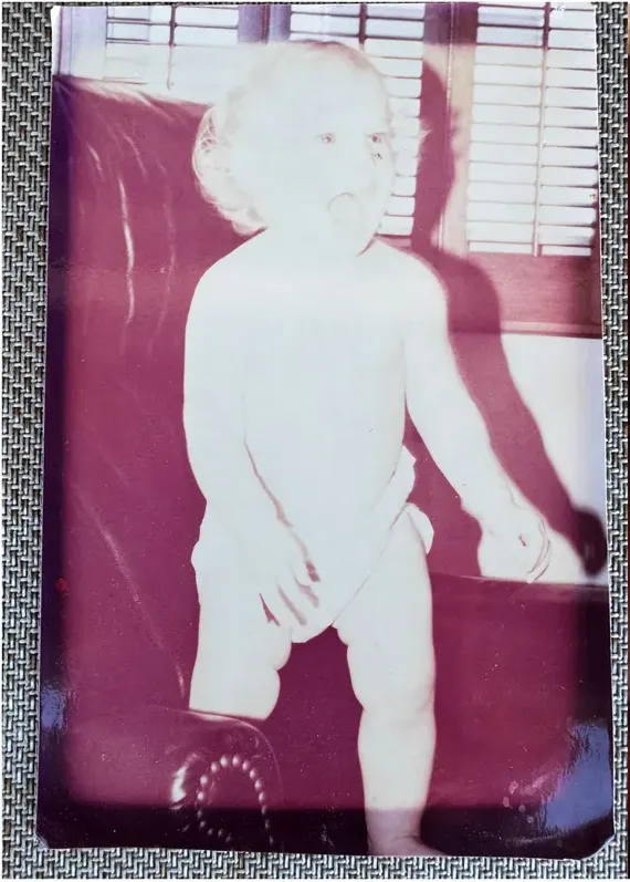 Creases and tears on a 1950s-1970s photograph, before hand restoration by MemoryCherish artists