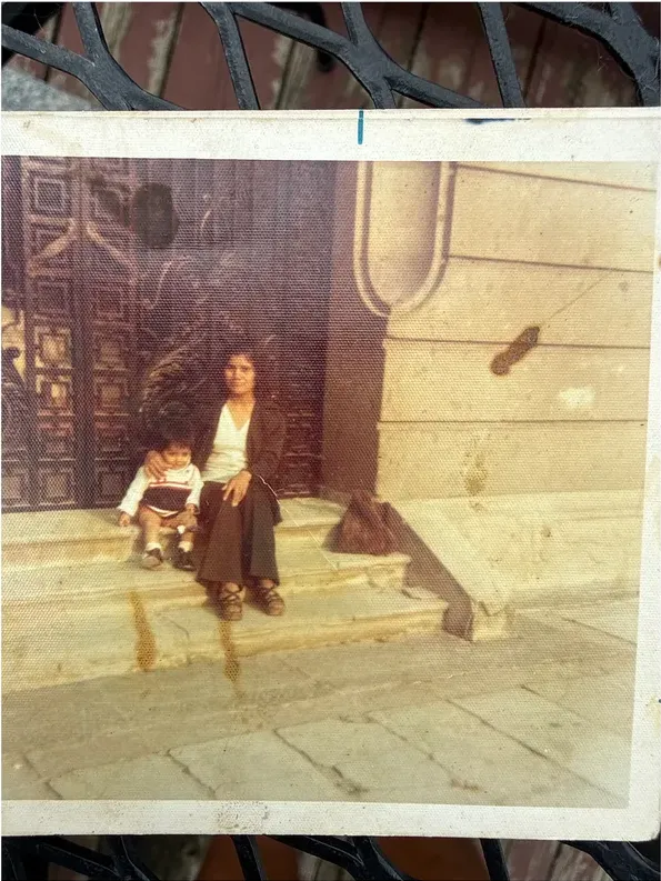 Water damage on a 1950s-1970s photograph, before hand restoration by MemoryCherish artists