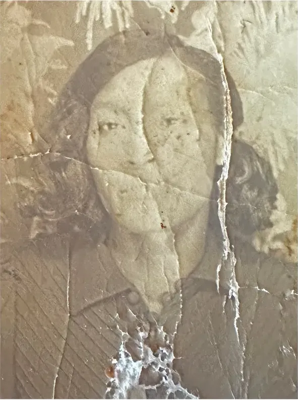Water damage on a pre-1950 photograph, before hand restoration by MemoryCherish artists