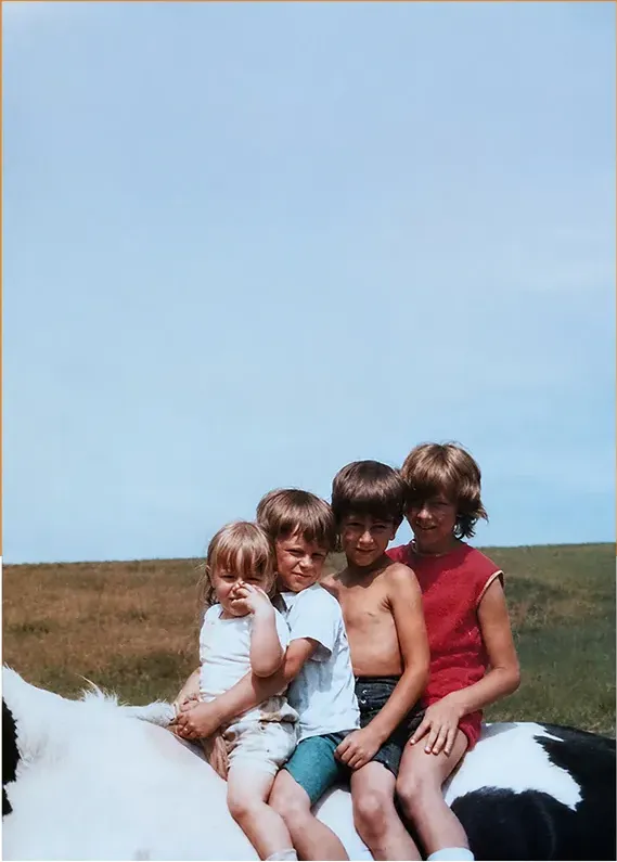 The same 1950s-1970s photograph after hand restoration by MemoryCherish, creases and tears repaired and detail recovered
