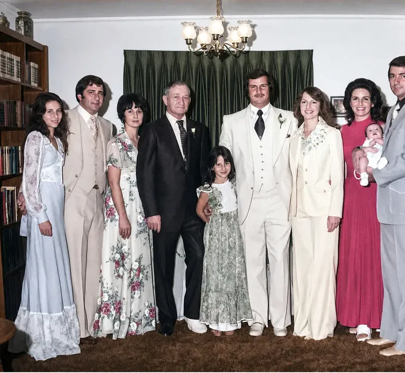 The same 1950s-1970s photograph after hand restoration by MemoryCherish, discoloration repaired and detail recovered