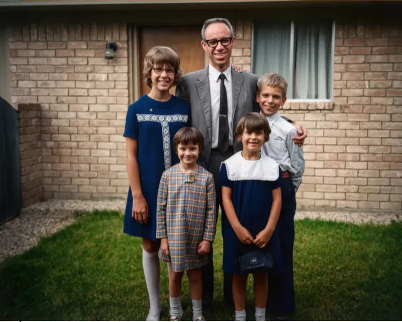 The same 1950s-1970s photograph after hand restoration by MemoryCherish, discoloration repaired and detail recovered