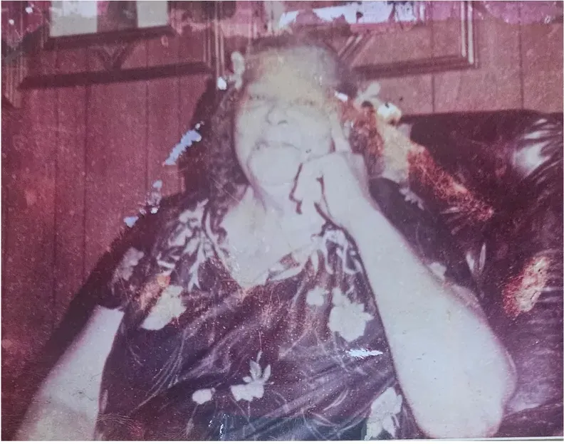 Water damage on a 1950s-1970s photograph, before hand restoration by MemoryCherish artists