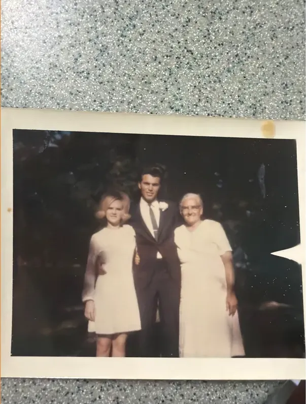 Creases and tears on a 1950s-1970s photograph, before hand restoration by MemoryCherish artists