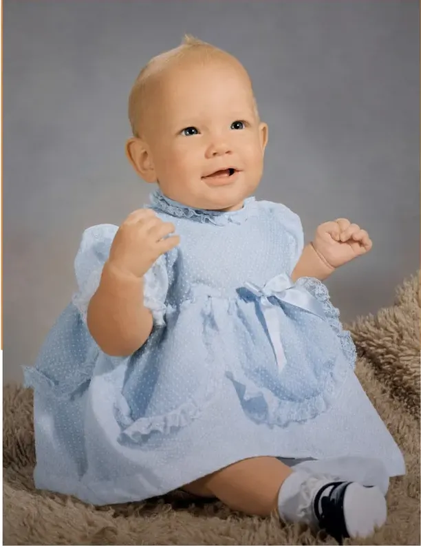 The same 1950s-1970s photo restored by hand at MemoryCherish, stains and marks corrected and clarity brought back