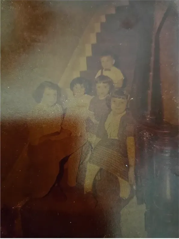 Water damage on a 1950s-1970s photograph, before hand restoration by MemoryCherish artists