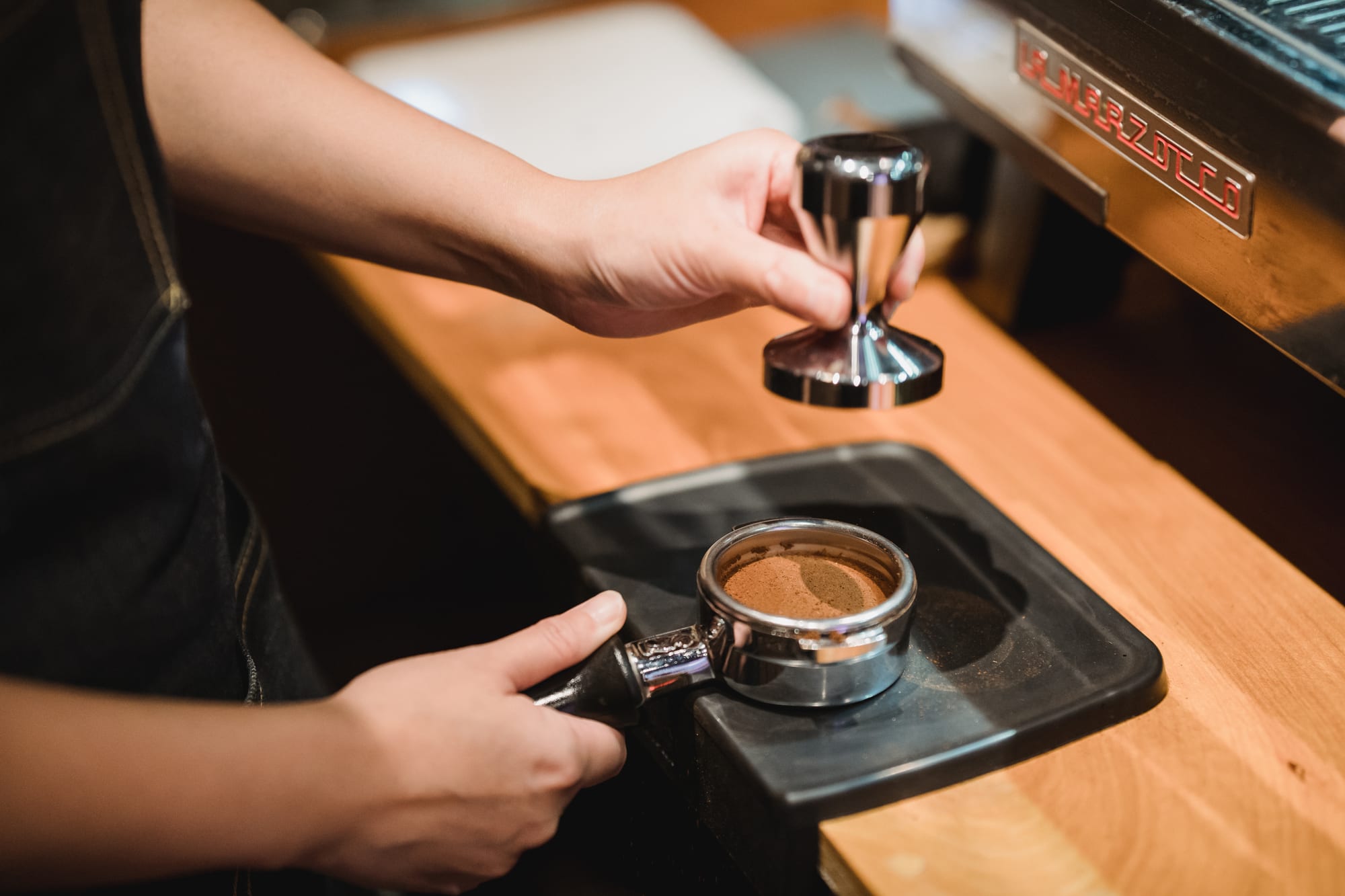 Free Barista Using a Tamper Stock Photo