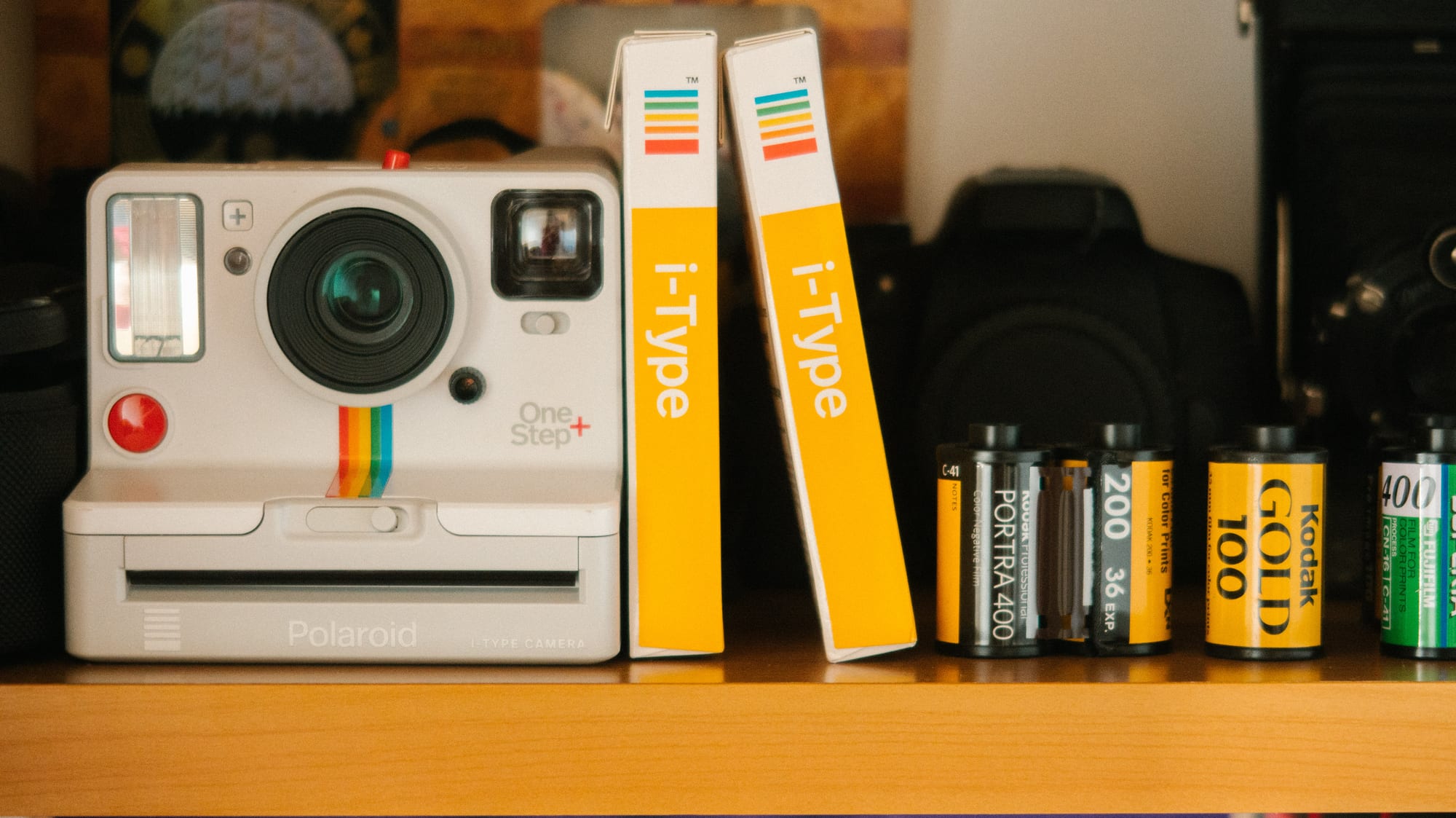Free White Polaroid Land Camera Beside Photo Paper Boxes and Photo Films Stock Photo