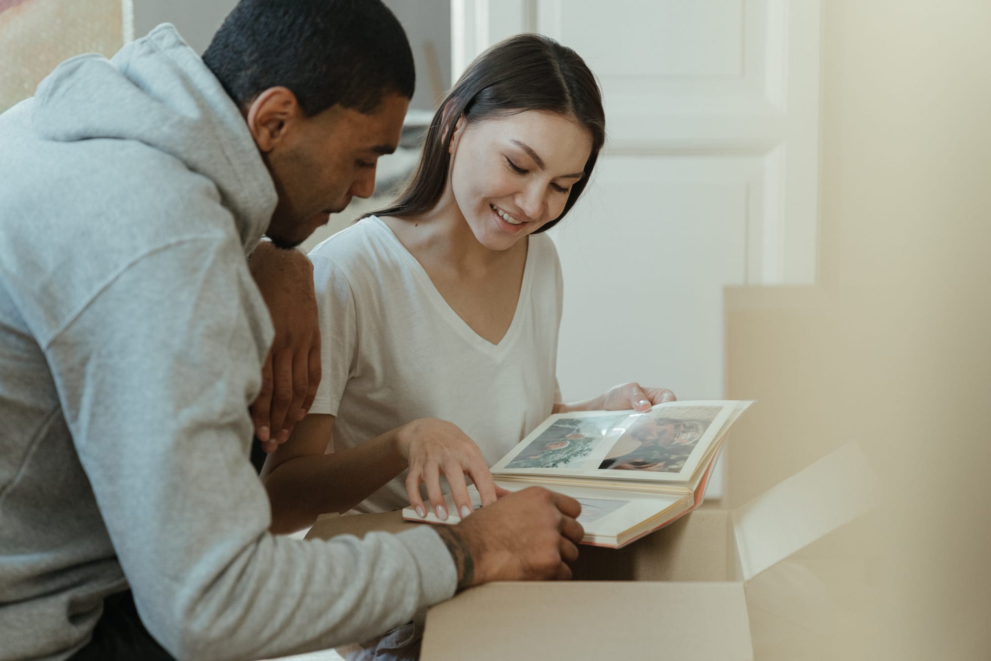 Free Woman in White Tank Top Sitting Beside Man in Gray Hoodie Stock Photo