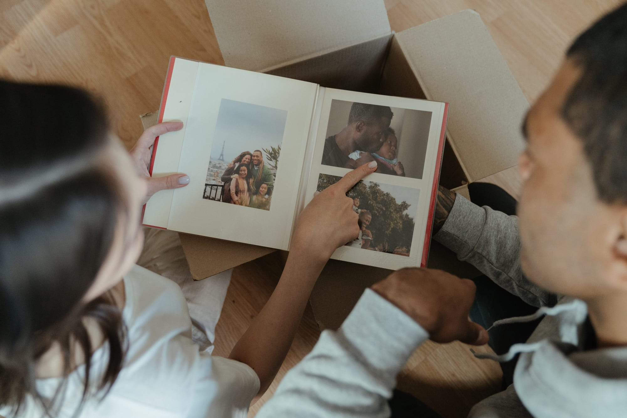 Free Person Holding 2 Photos of 2 Women Stock Photo