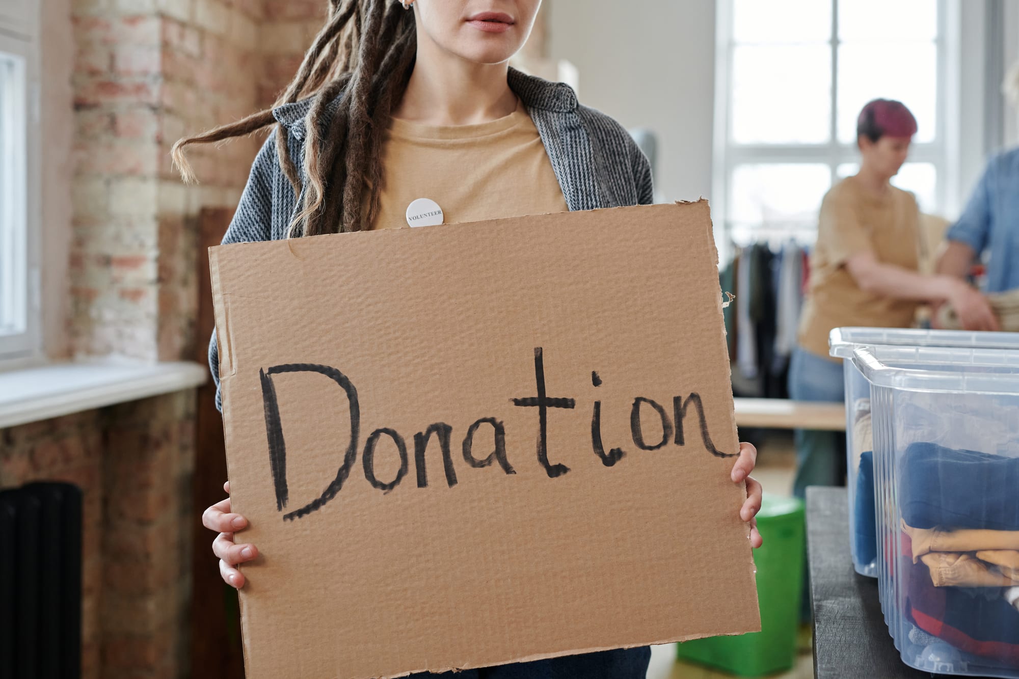 Free A Woman Holding a Cardboard with Inscription Stock Photo