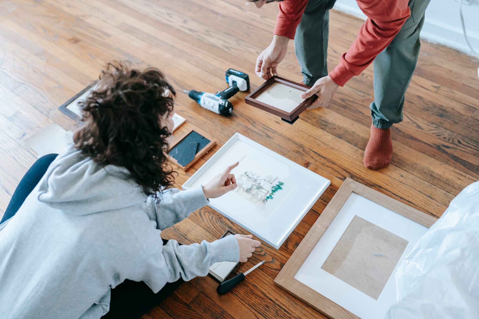 Free Couple Arranging Picture Frames Stock Photo