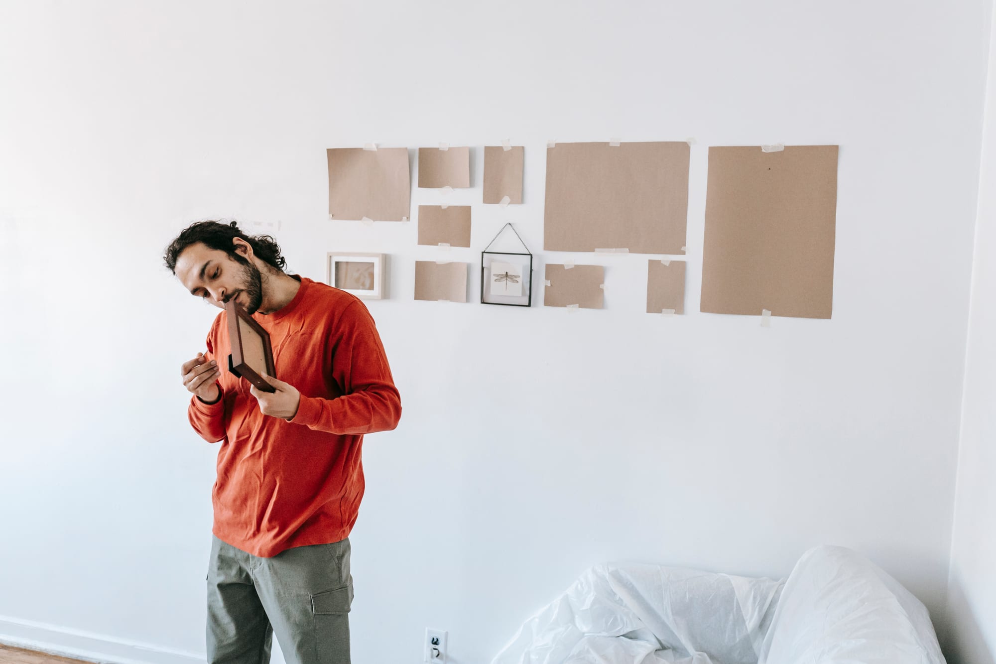 Free Man in Red Crew Neck Shirt Holding A Picture Frame Stock Photo