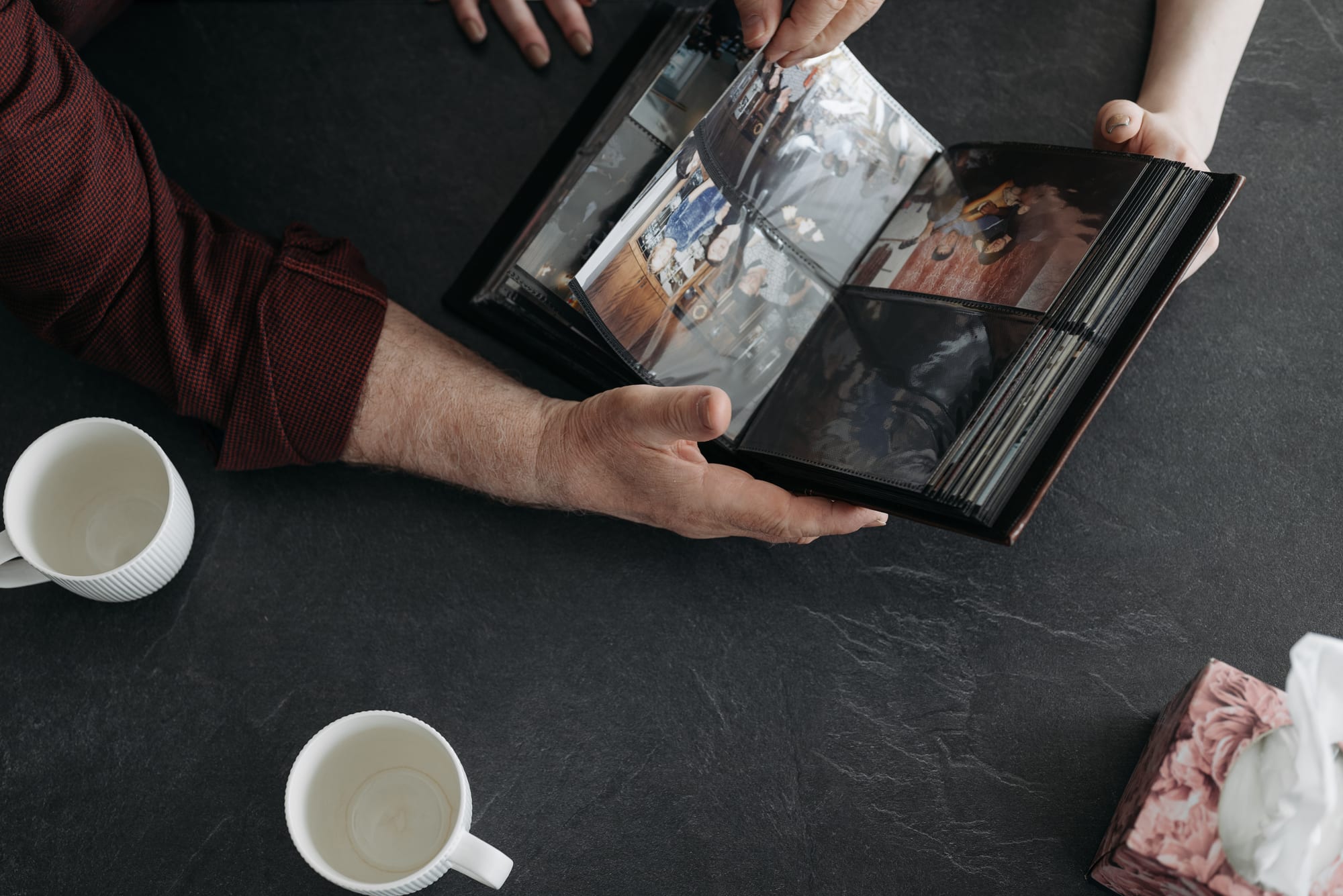 Free A Person Holding a Black Photo Album Stock Photo