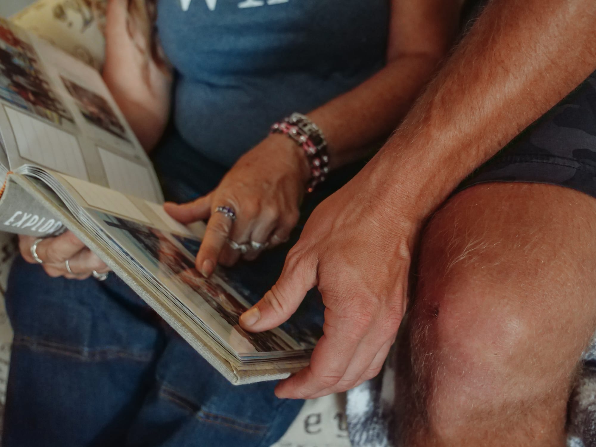 Free People Looking at the Photo Album they're Holding Stock Photo